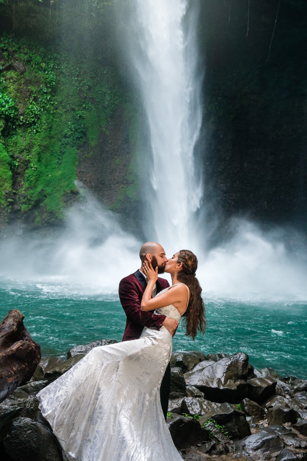 Couple kissing by waterfall